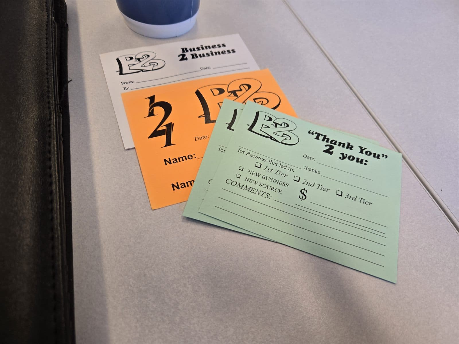 B2B Bedford referral cards — a green Thank You 2 You card with tiered business fields alongside blank member cards
